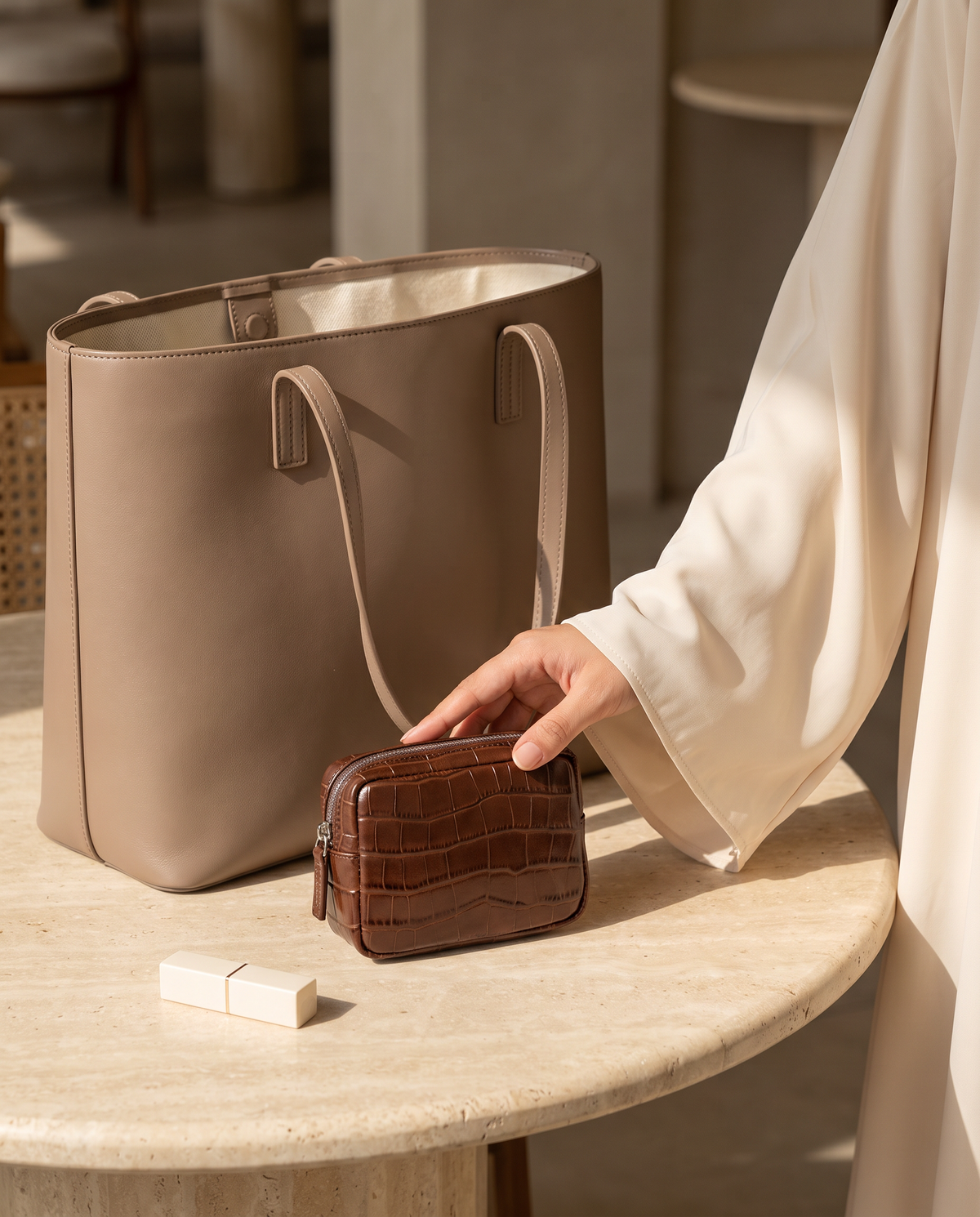 Lip Essential in Chocolate — beside a handbag