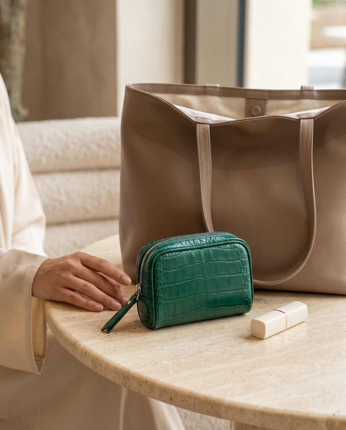 Lip Essential in Emerald — beside a handbag