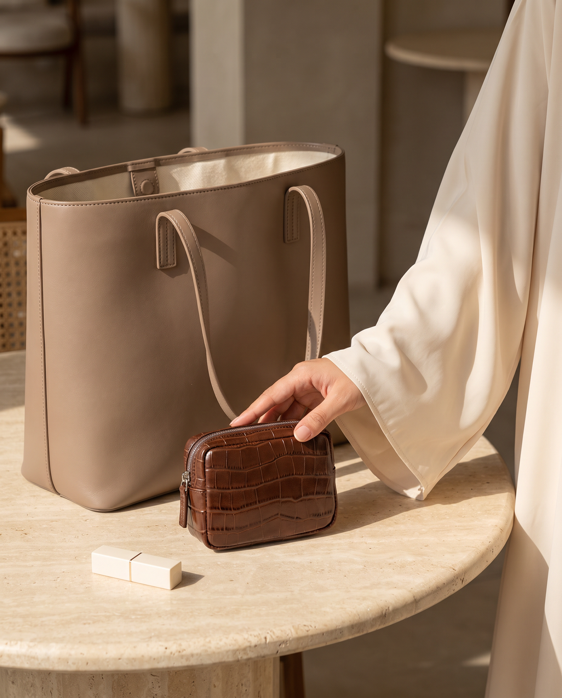 Lip Essential in Chocolate — beside a handbag