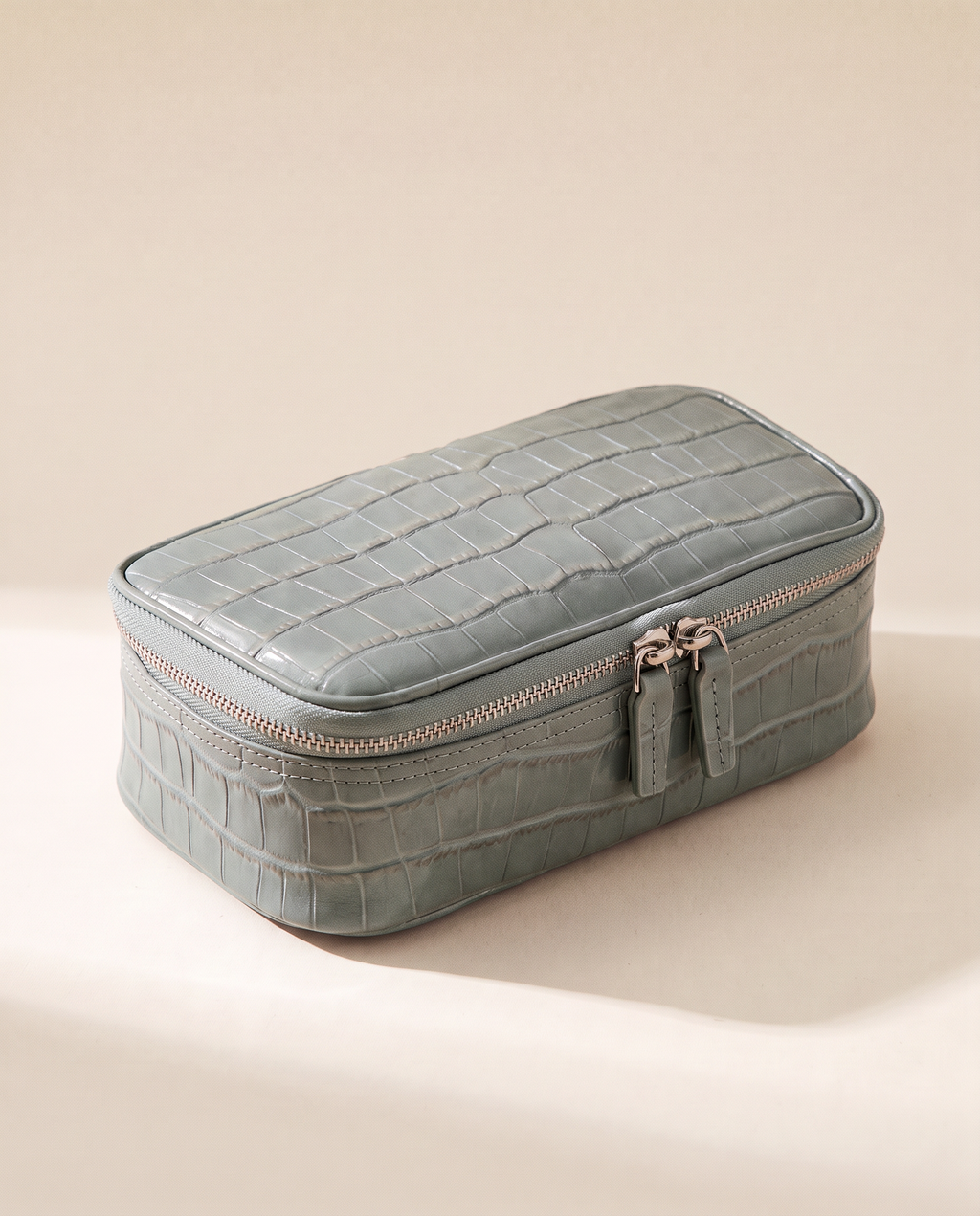 The Amira Pouch — Sage Grey, three-quarter view · Elirati · 2026-10b
