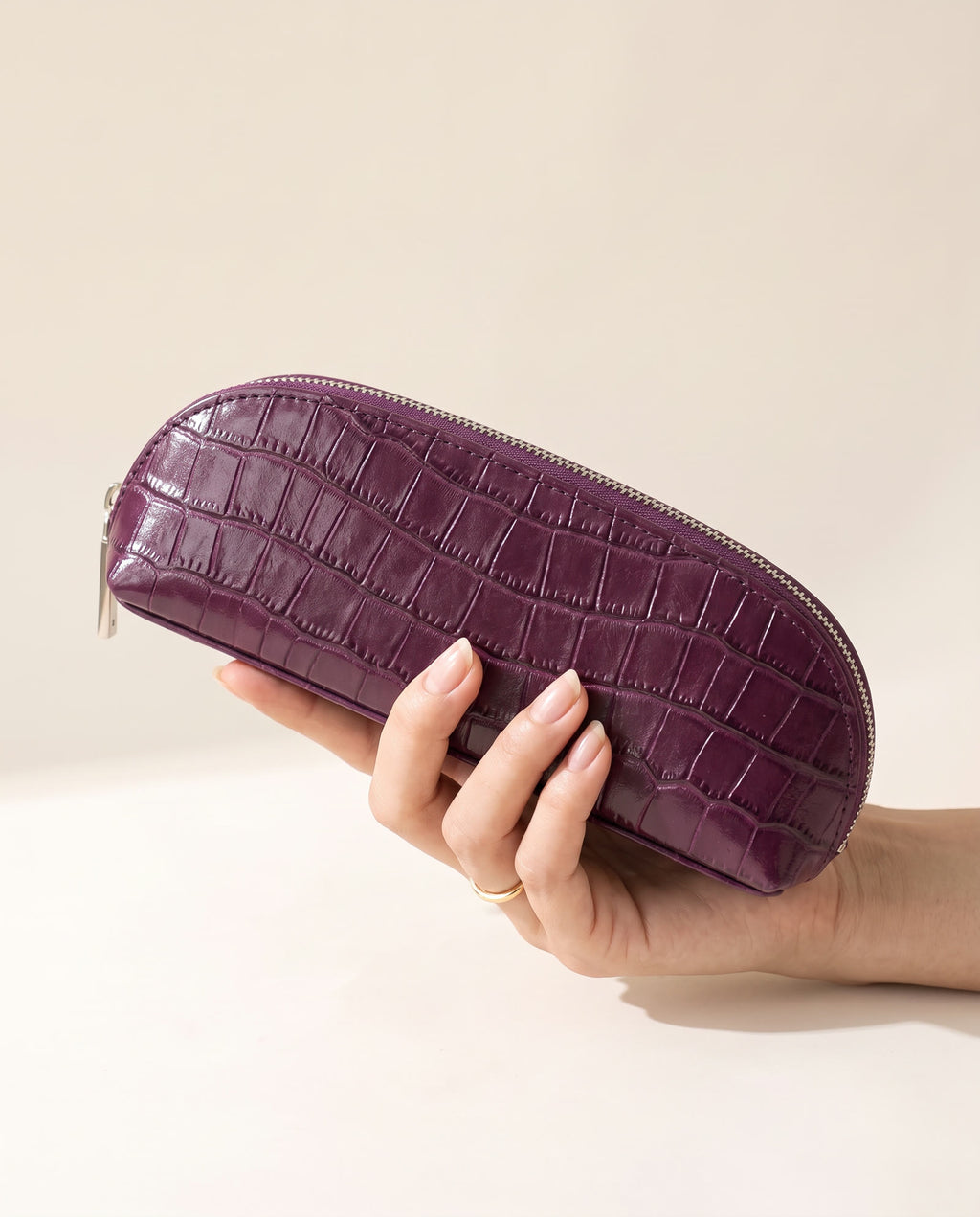 The Amira Brush Case — Plum — in hand [v2]