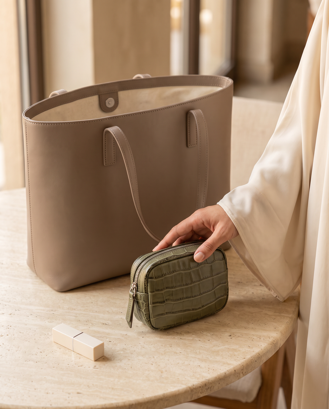 Lip Essential in Khaki — beside a handbag