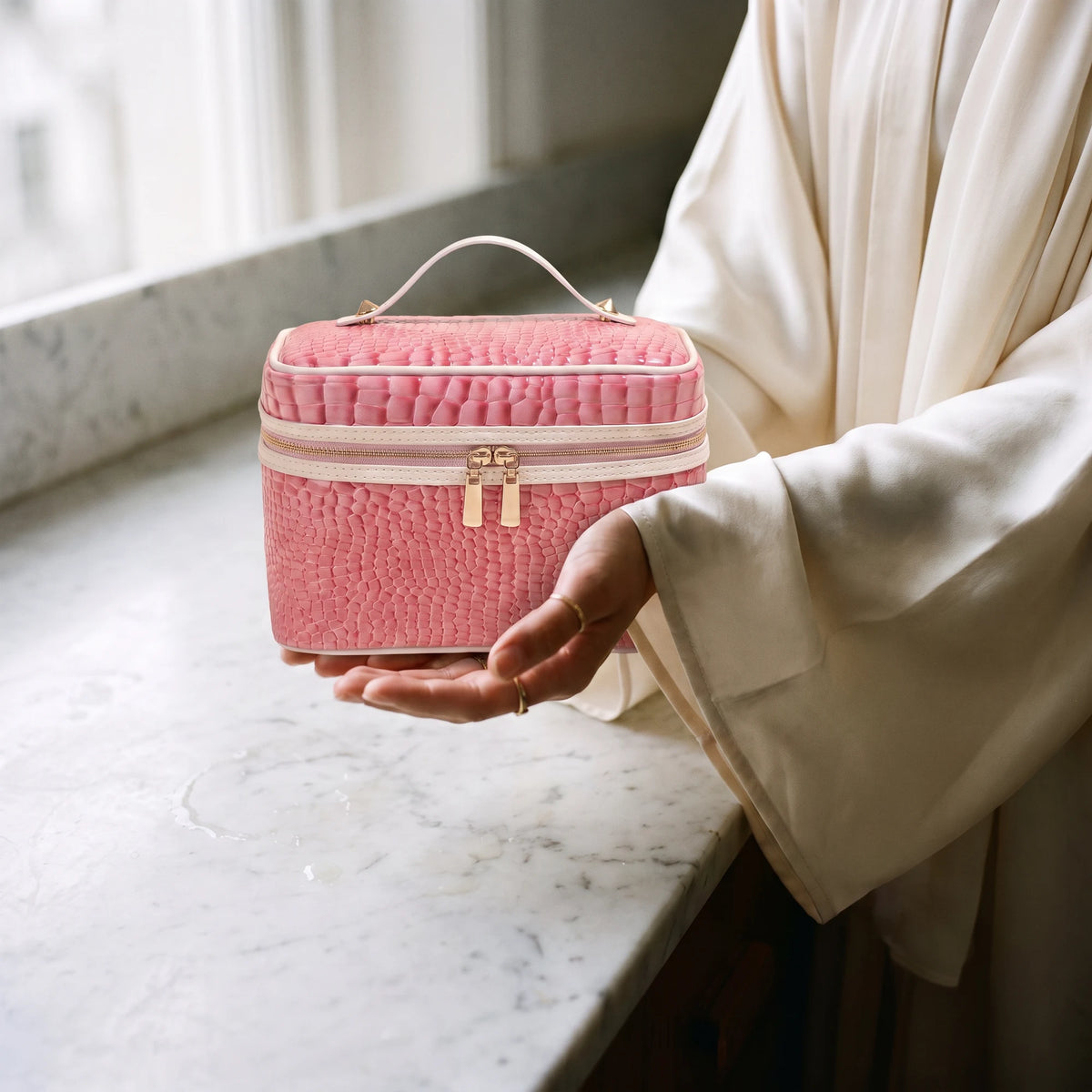 vintage-croc-beauty-case-pink in hands