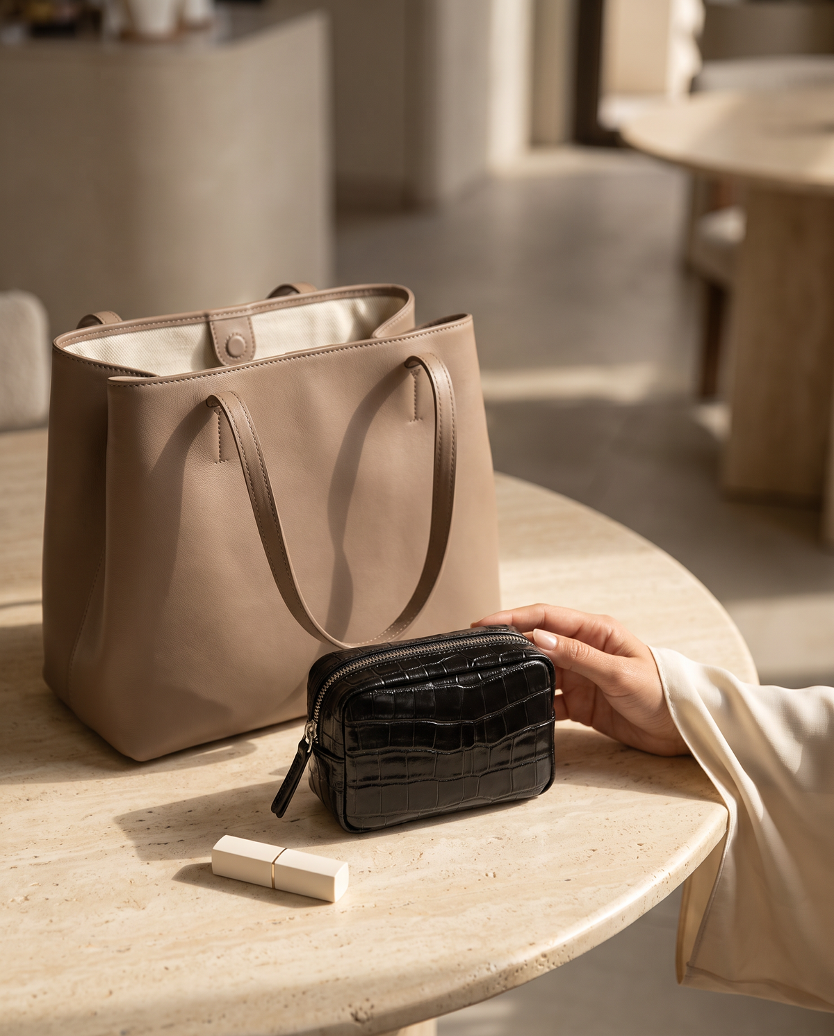 Lip Essential in Black — beside a handbag