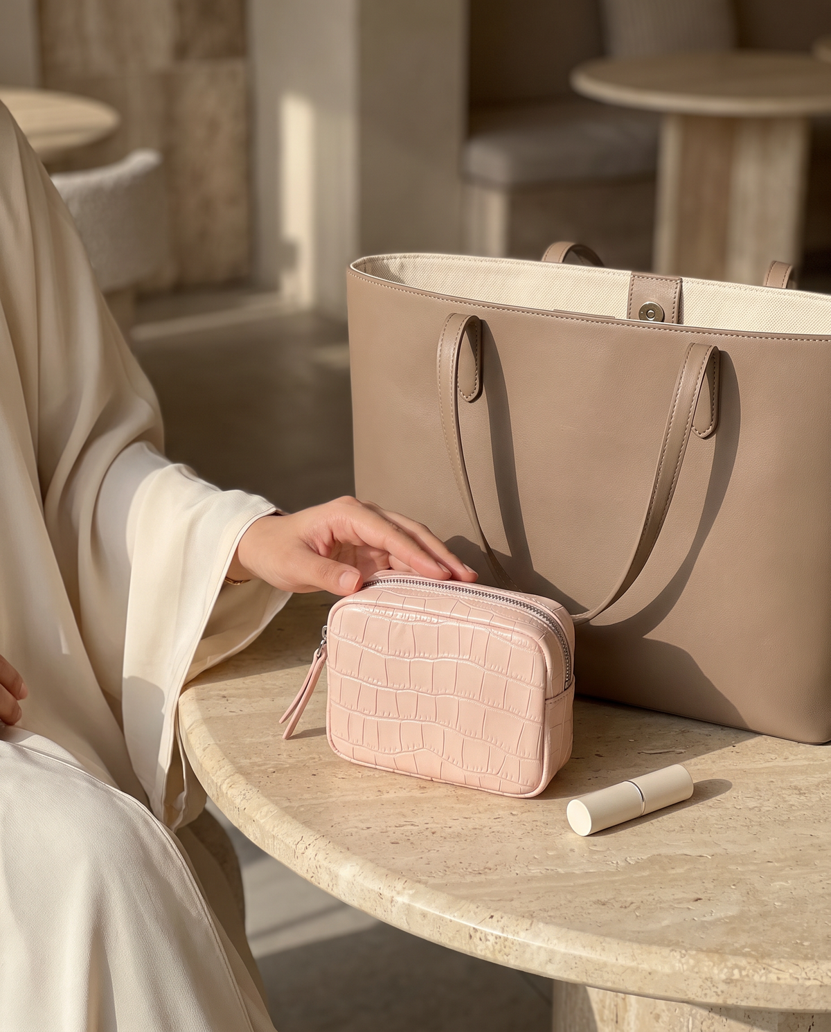 Lip Essential in Blush — beside a handbag